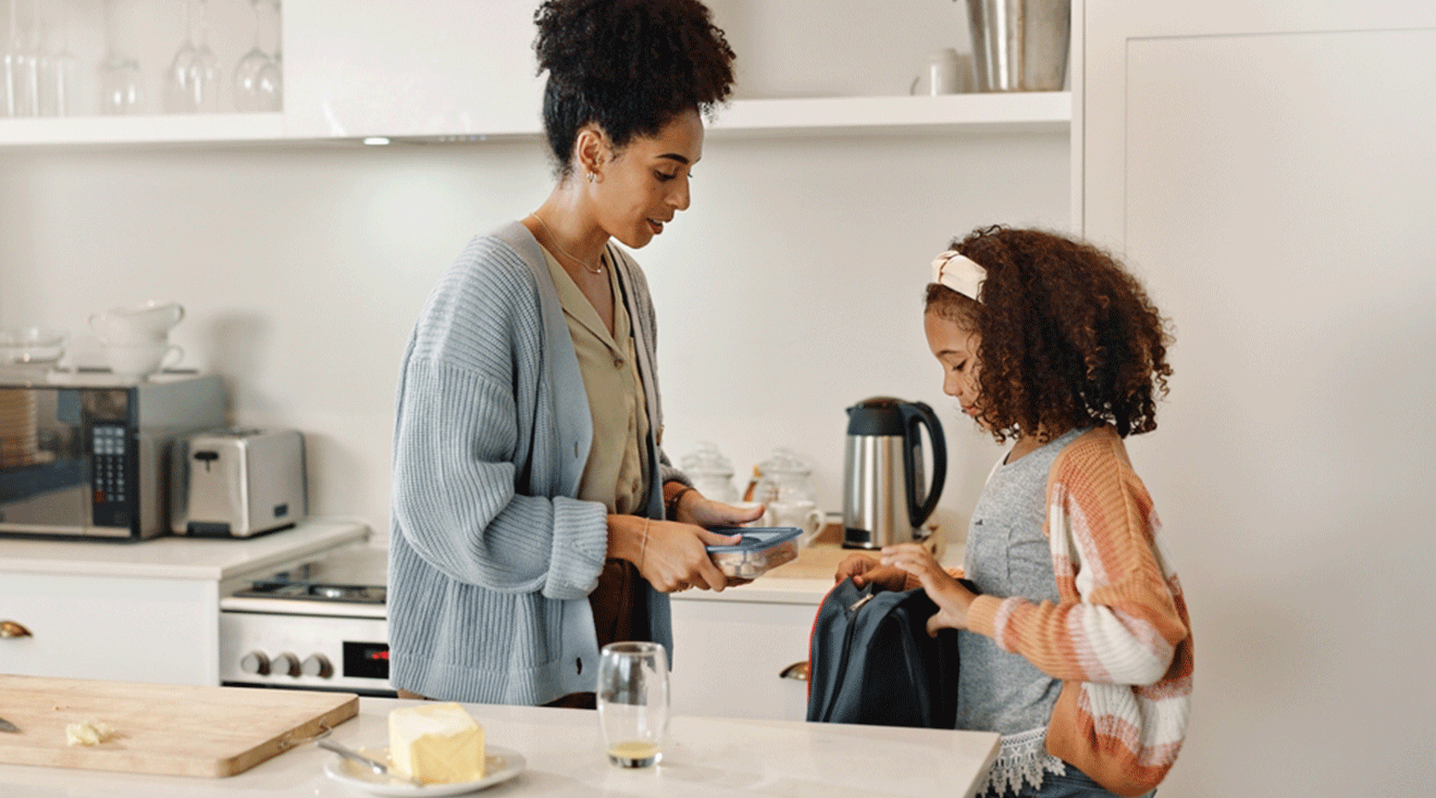 mom packing a lunch for daughter