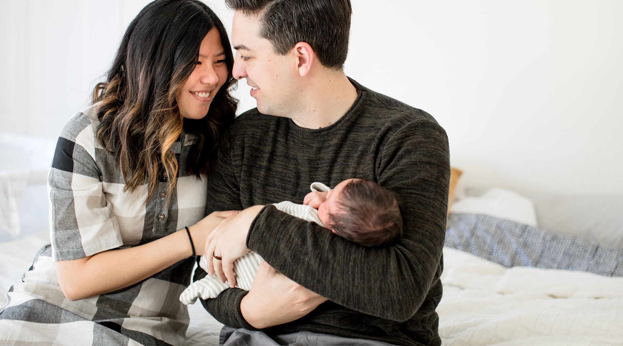 happy young parents holding their newborn