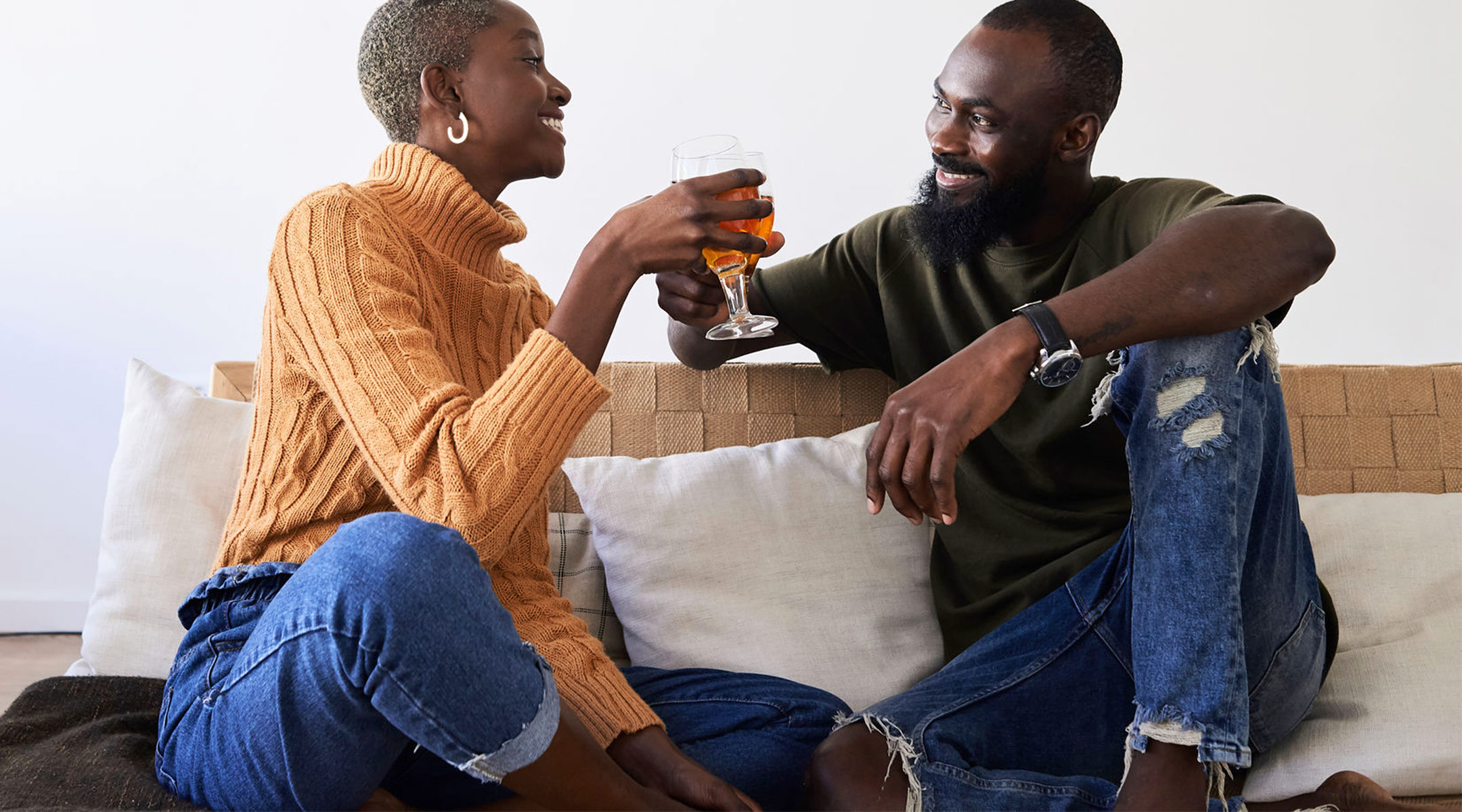 couple drinking beer at home on the couch