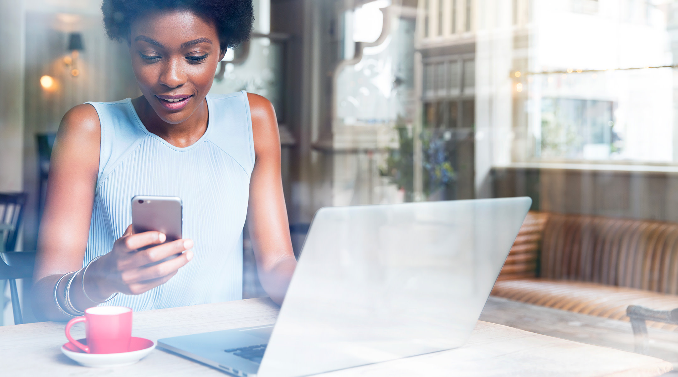 woman smiling on computer searching for ob-gyn