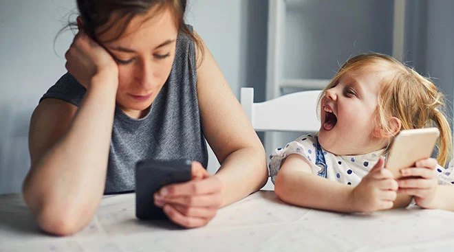 toddler acting out sitting next to stressed out mom