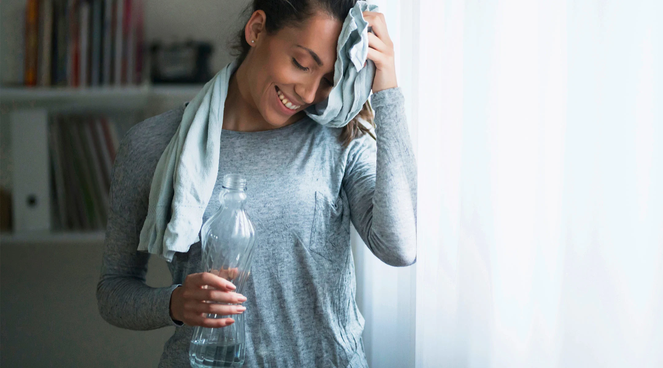 woman wiping sweat from her brow after a workout