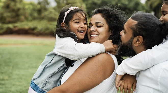 happy family laughing outside