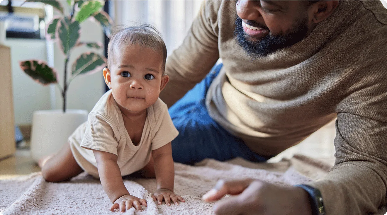dad and baby doing tummy time and crawling