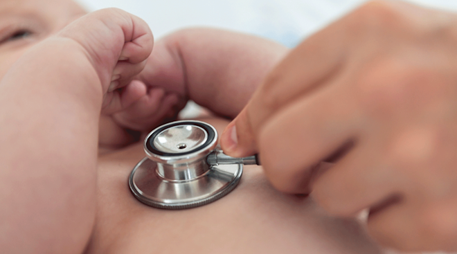Doctor listens to newborn baby heart with stethoscope