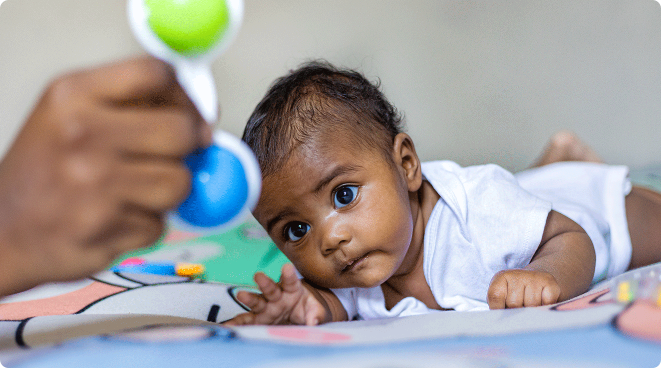 mom playing with baby during tummy time