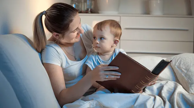 mom and toddler looking at photo album