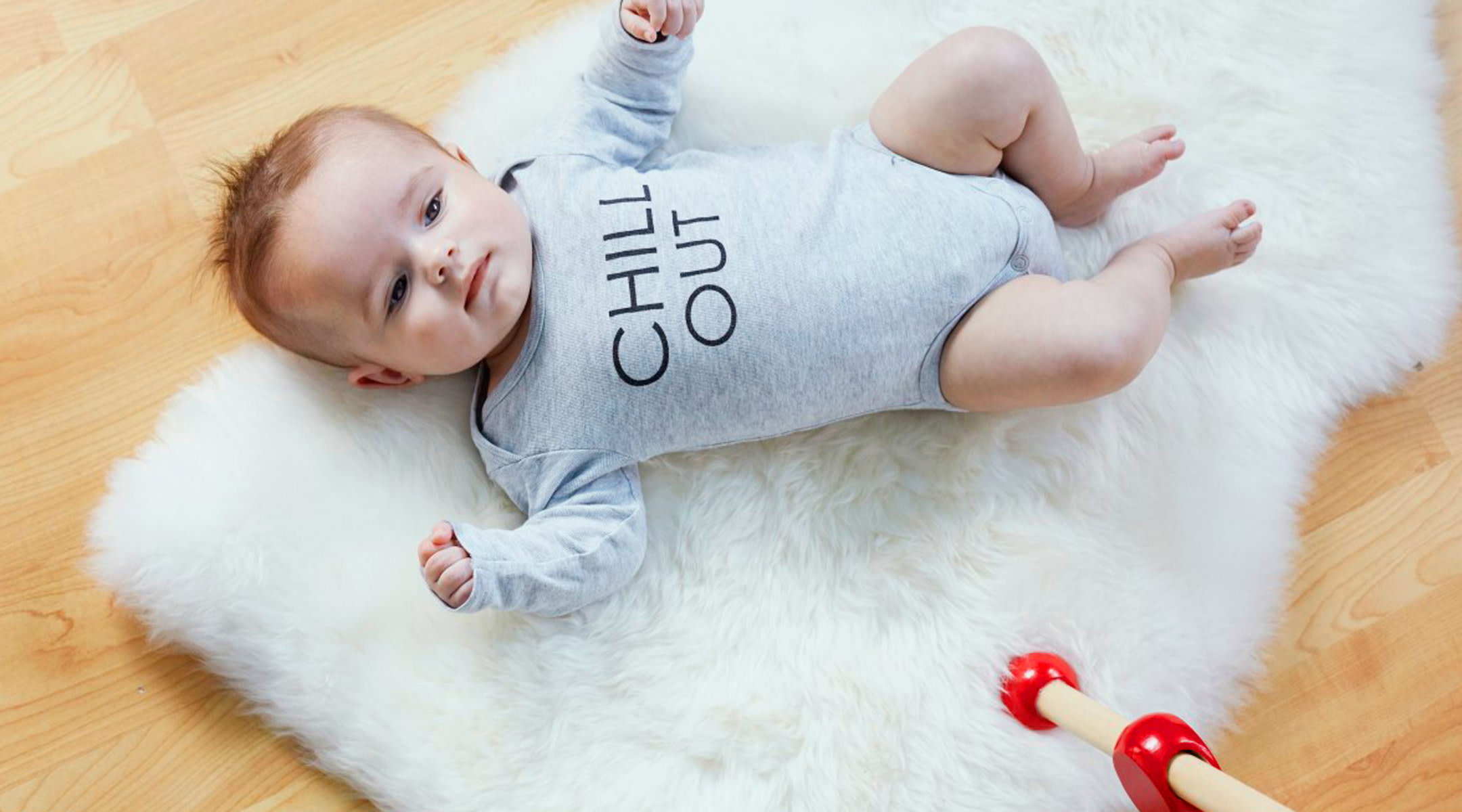 Baby wearing onesie that says chill out. 
