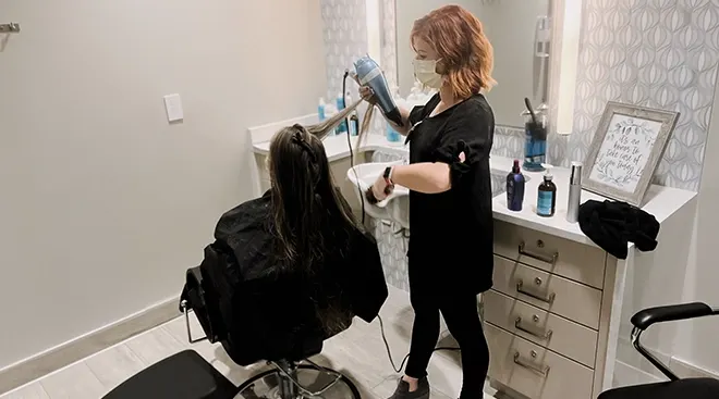 Sarah Pulley doing a mother's hair in NICU beauty bar hair salon