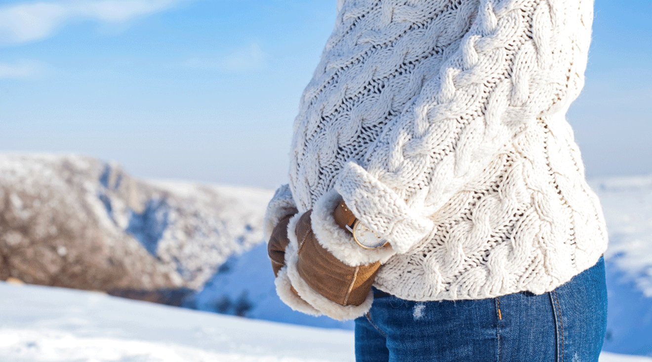 pregnant woman on a snowy mountain during the winter