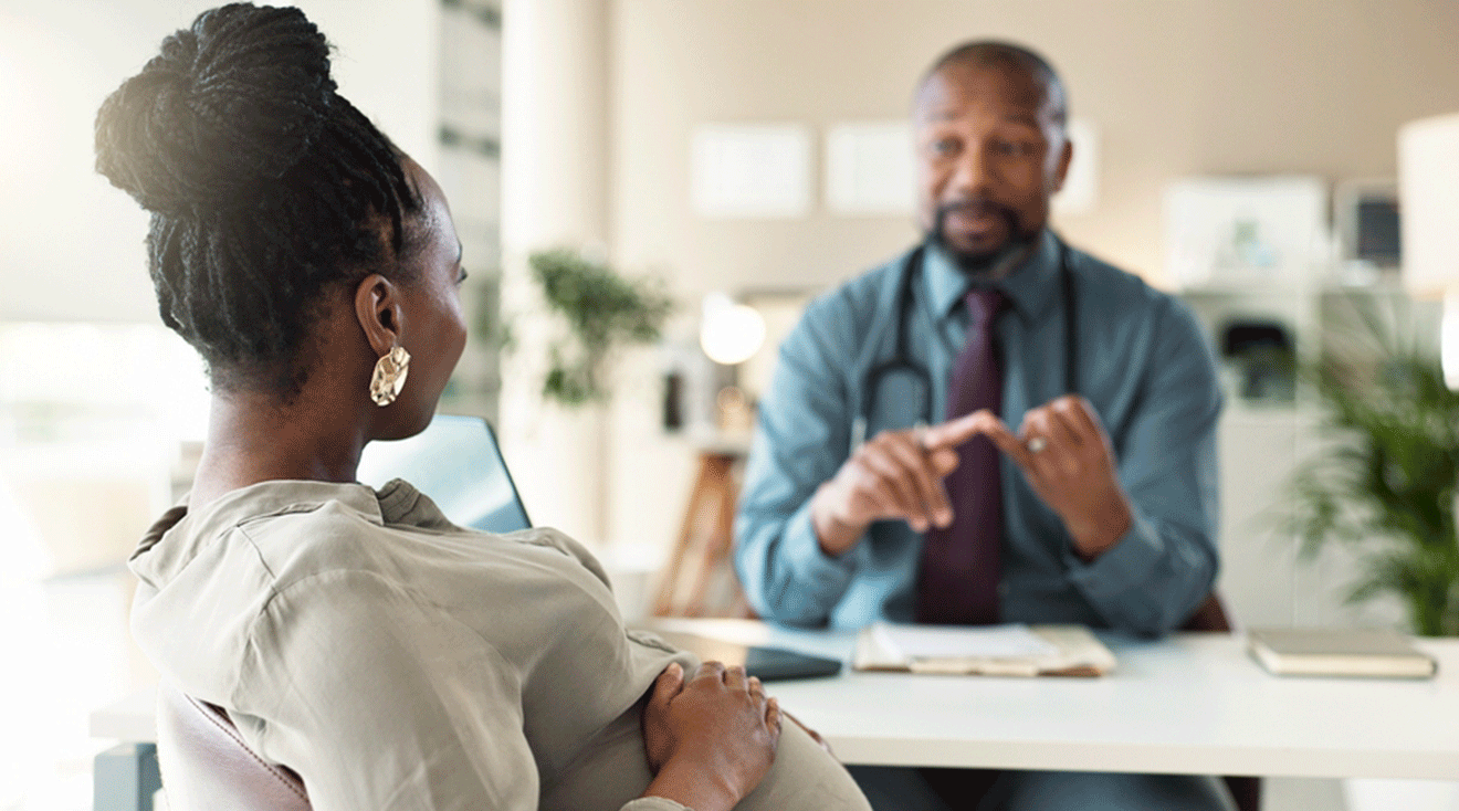 pregnant woman talking to doctor