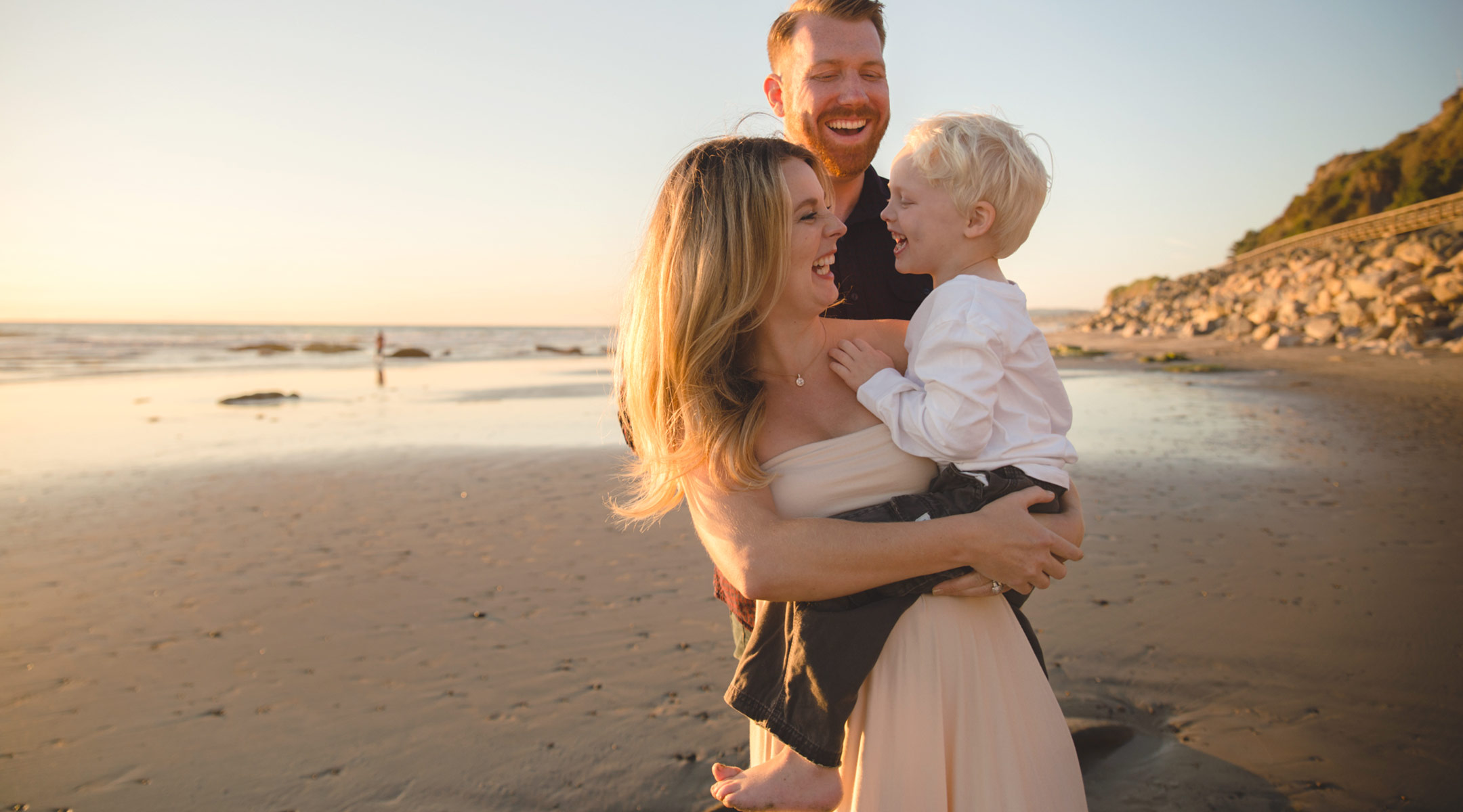 happy family of three on the beach