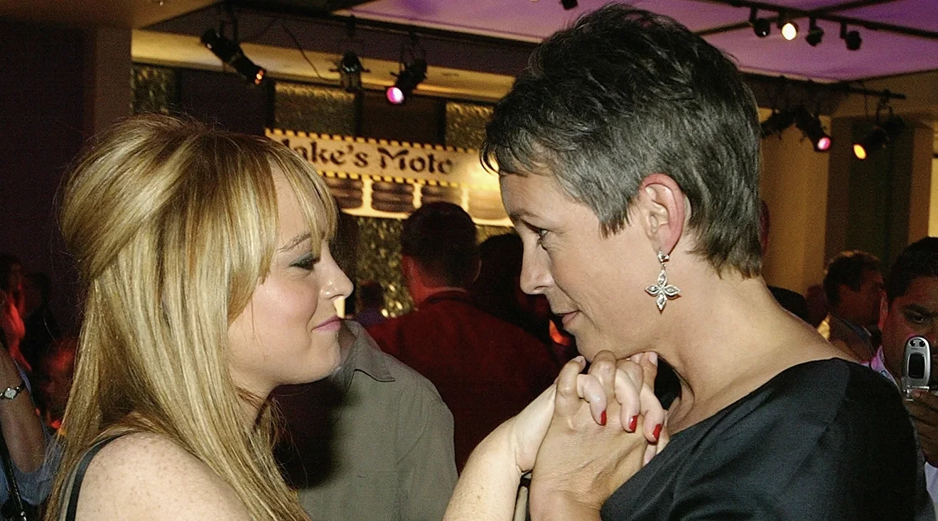 Jamie Lee Curtis takes Lindsay Lohan's hands as she talks to her during an after party at the Annex following the premiere of the Disney film Freaky Friday August 4, 2003 in Hollywood, CA