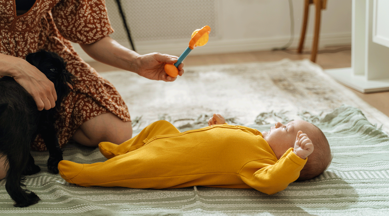 mom playing with infant at home