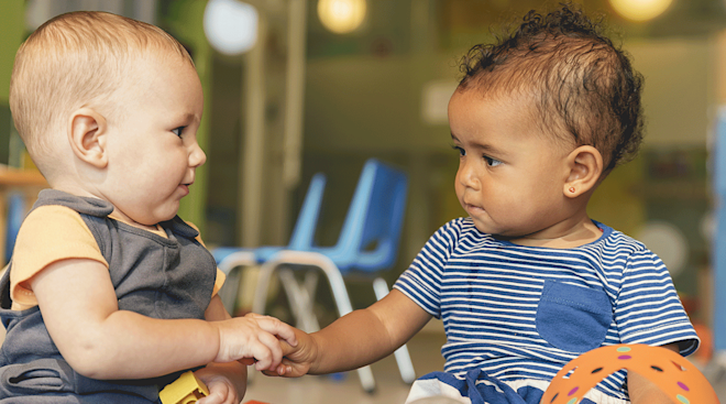 2 babies playing together at daycare