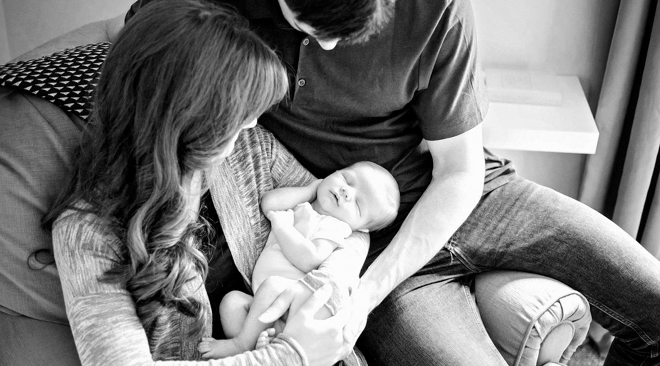 happy family holding newborn baby