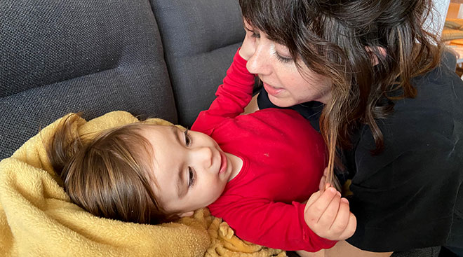 mom embracing her toddler on the couch