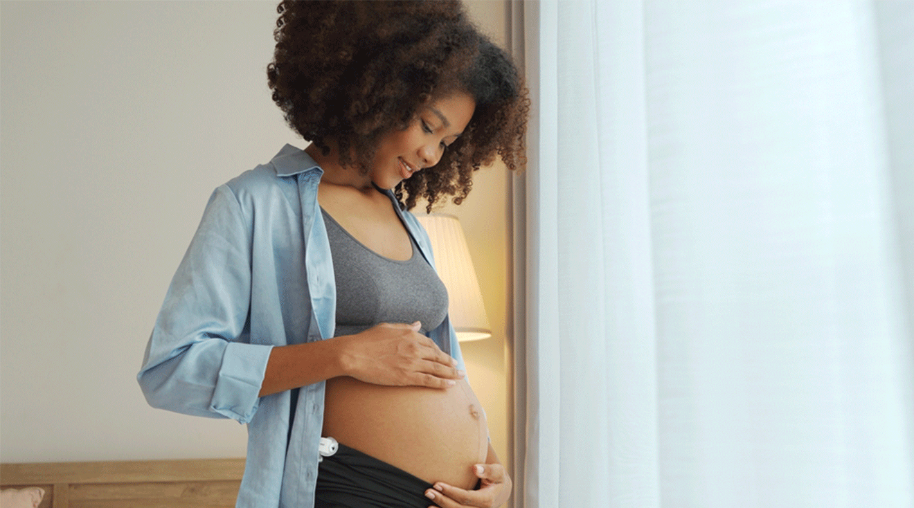 pregnant woman looking at belly