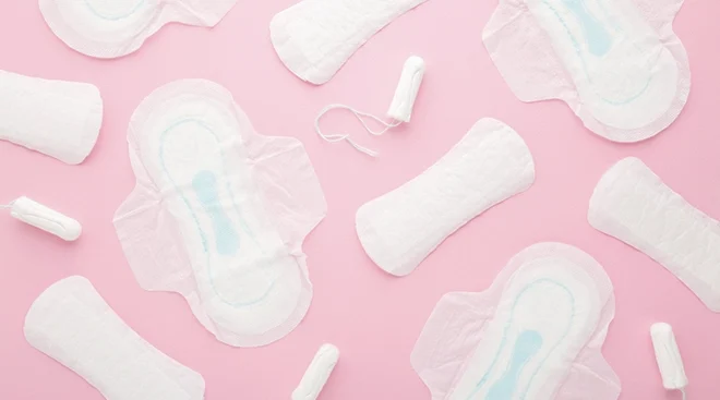 pads and tampons on pink background