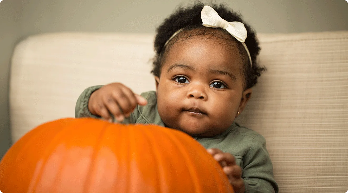 baby with pumpkin