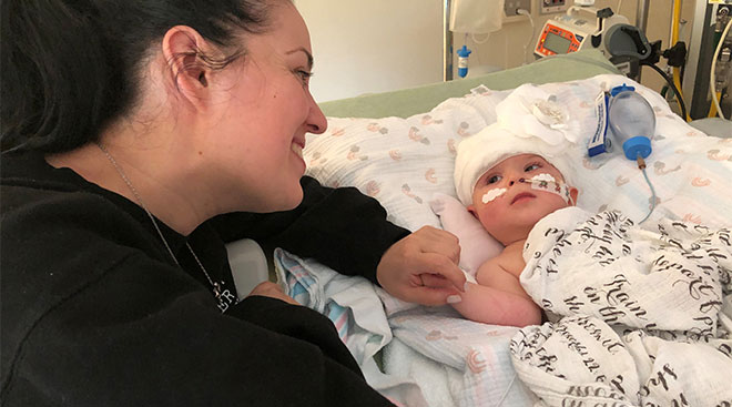 mother interacting with her daughter at the hospital after conjoined twin surgery