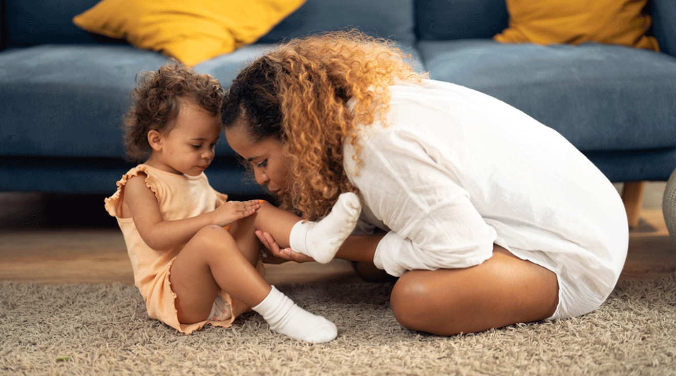 mom treating toddler boo boo