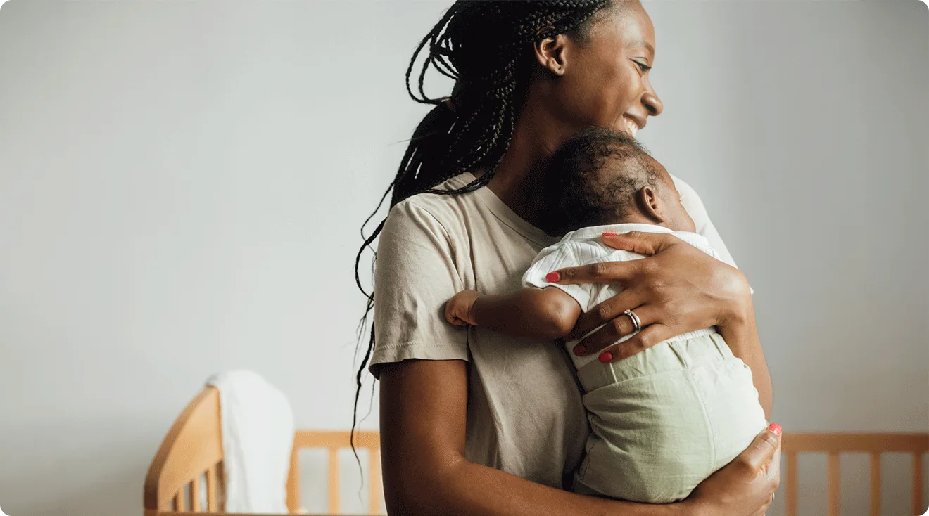 mom holding newborn baby at home