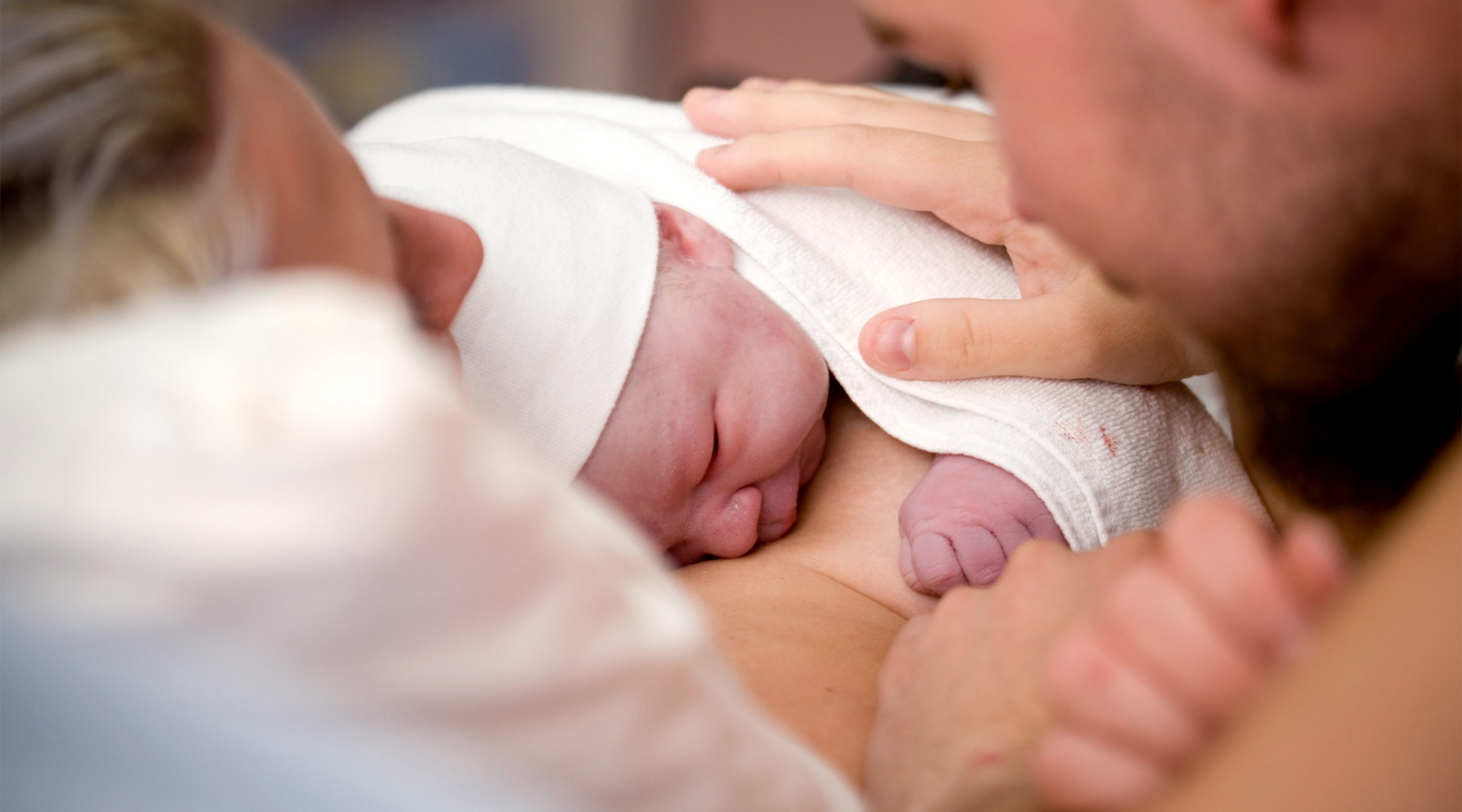 couple looking at newborn baby