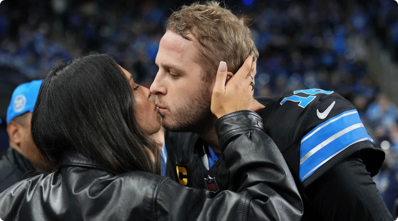 Jared Goff #16 of the Detroit Lions receives a kiss from his wife, Christen Harper Goff on field prior to the game against the Buffalo Bills at Ford Field on December 15, 2024 in Detroit, Michigan