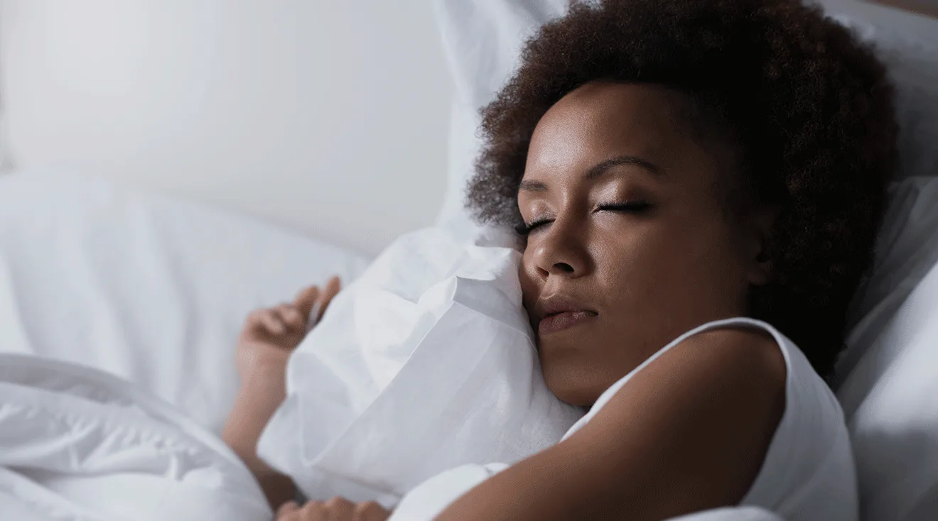young woman asleep in bed at night