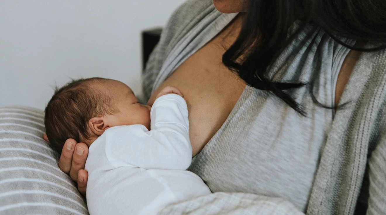 mother breastfeeding newborn baby