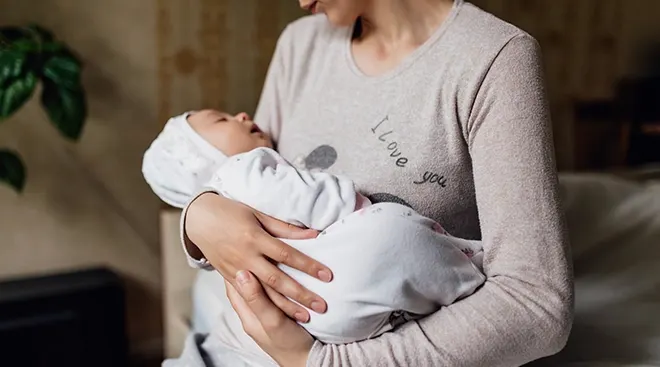 mother holding baby