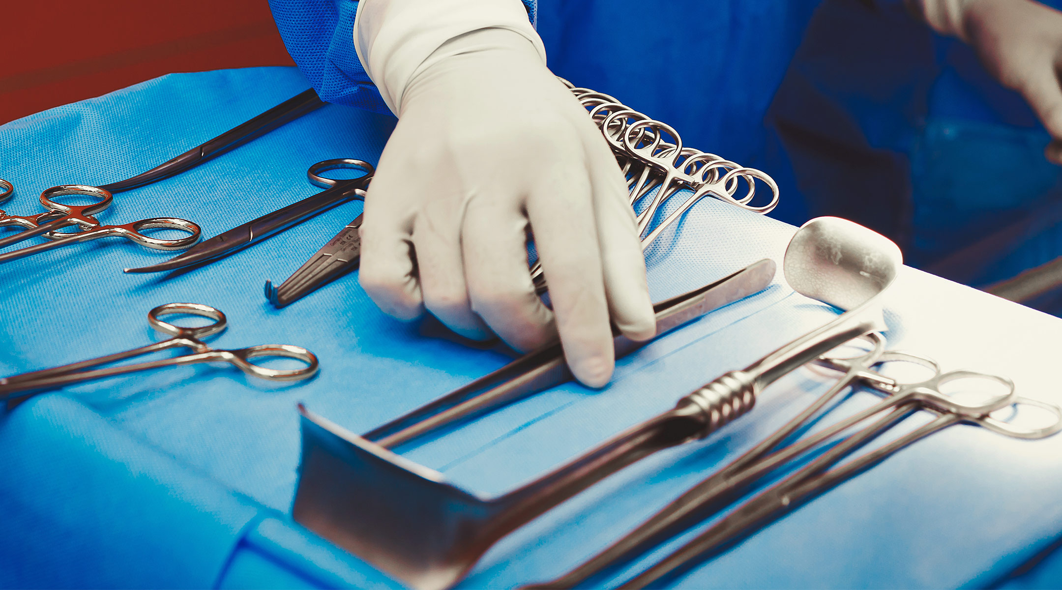 surgeon's hand selecting tools for operation