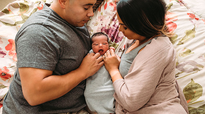 parents holding their newborn baby