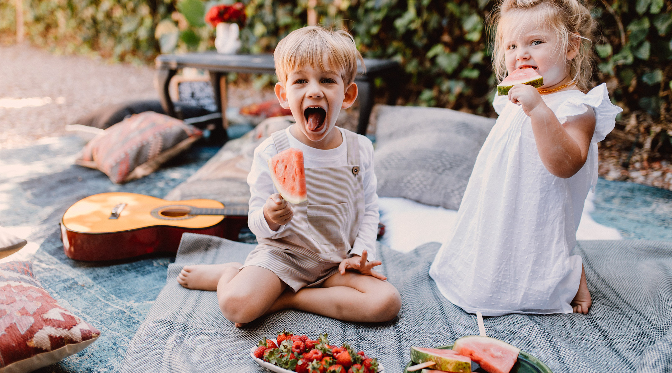 excited children eating watermelon at a picnic