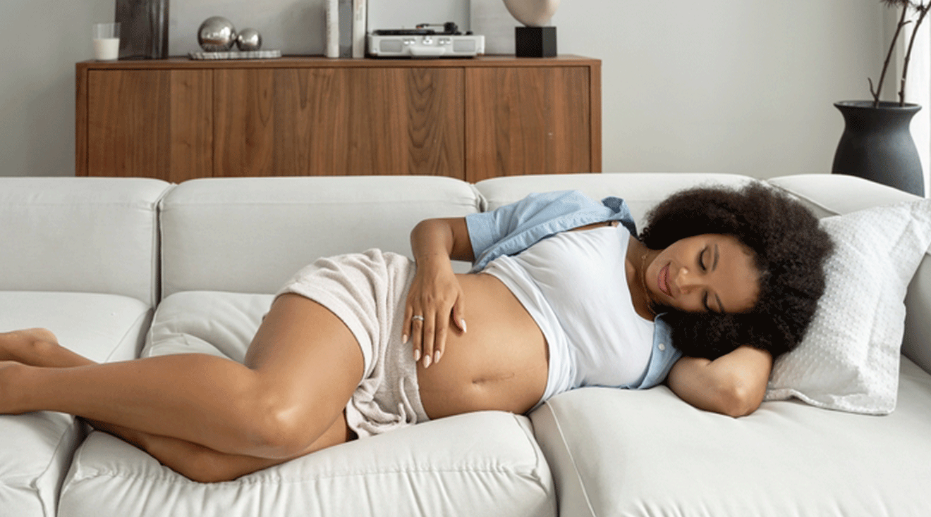 pregnant woman lying on couch at home