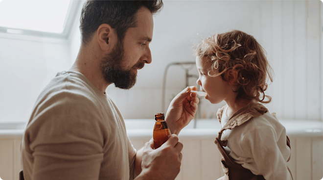 dad giving toddler medicine