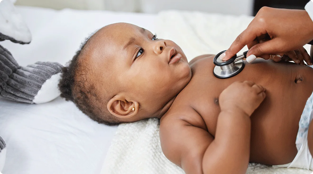 pediatrician listening to baby's heart