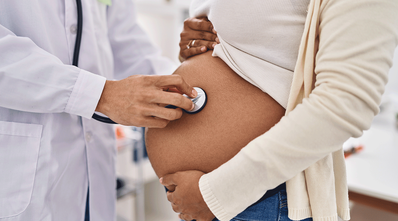 pregnant woman getting checked by doctor