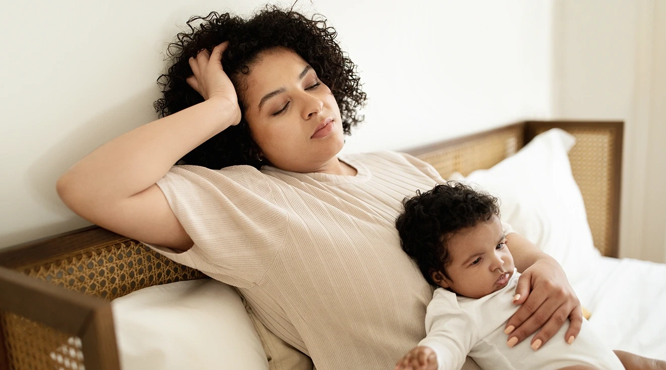 tired mom holding baby