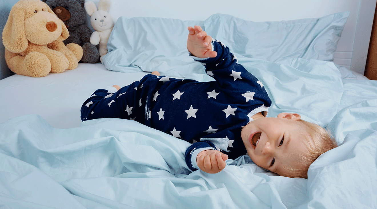 toddler in pajamas laughing before bedtime