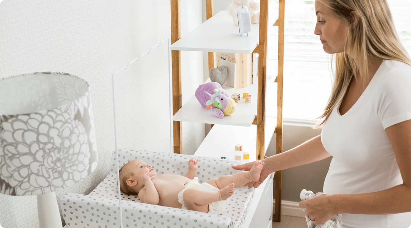 mom changing baby's diaper