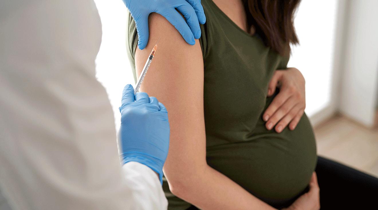 pregnant woman receiving a vaccination