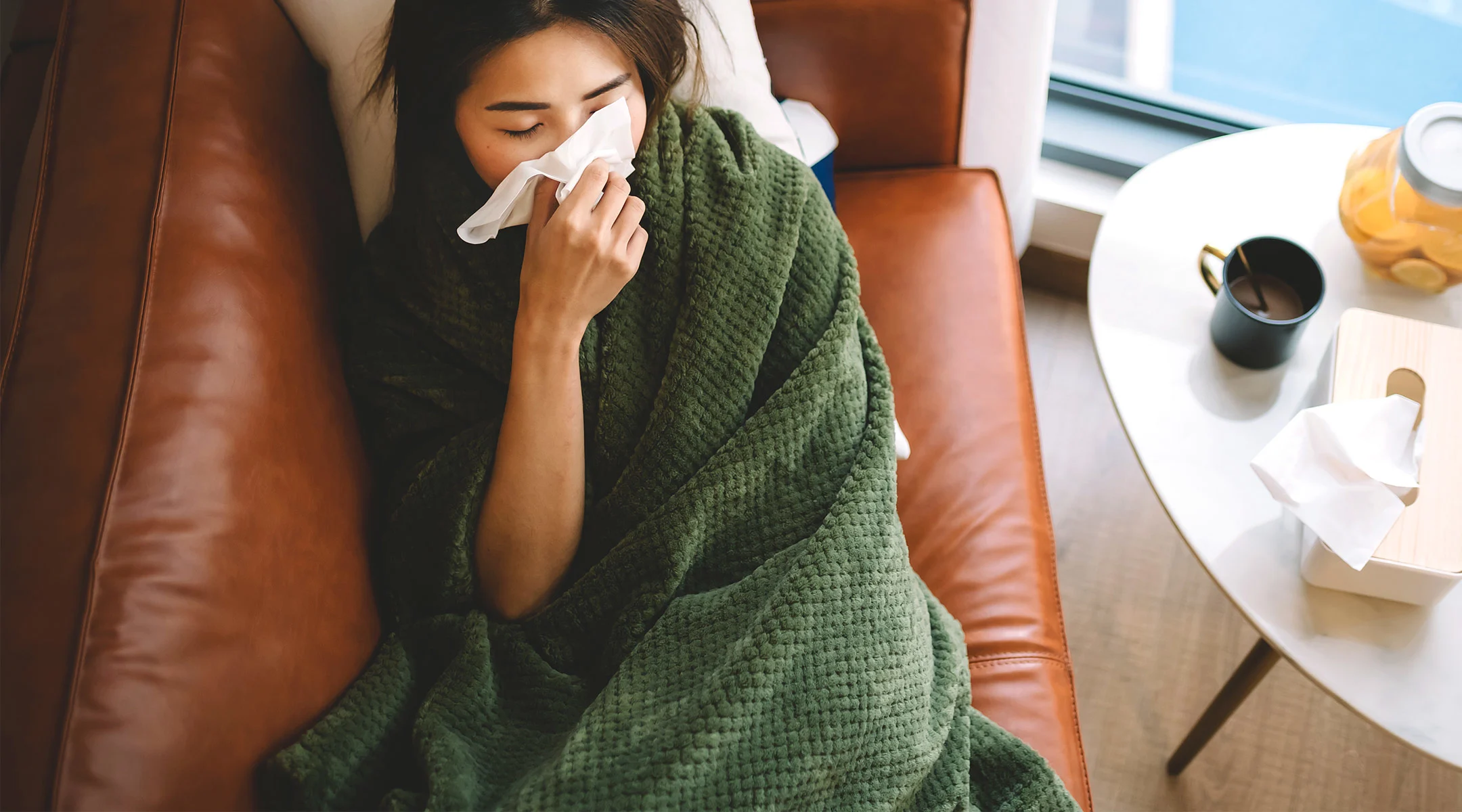 sick woman laying on couch