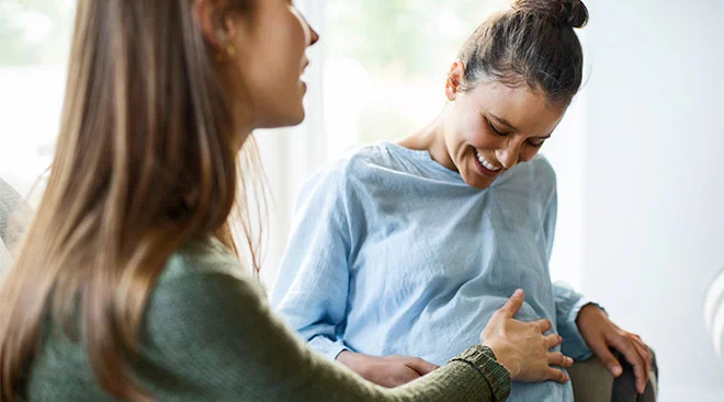 Doula helping pregnant woman.