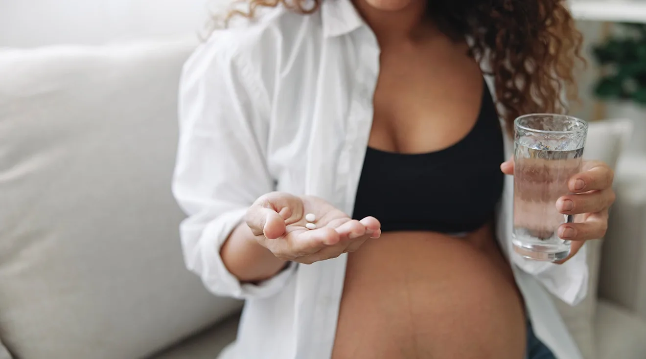 pregnant woman taking medicine