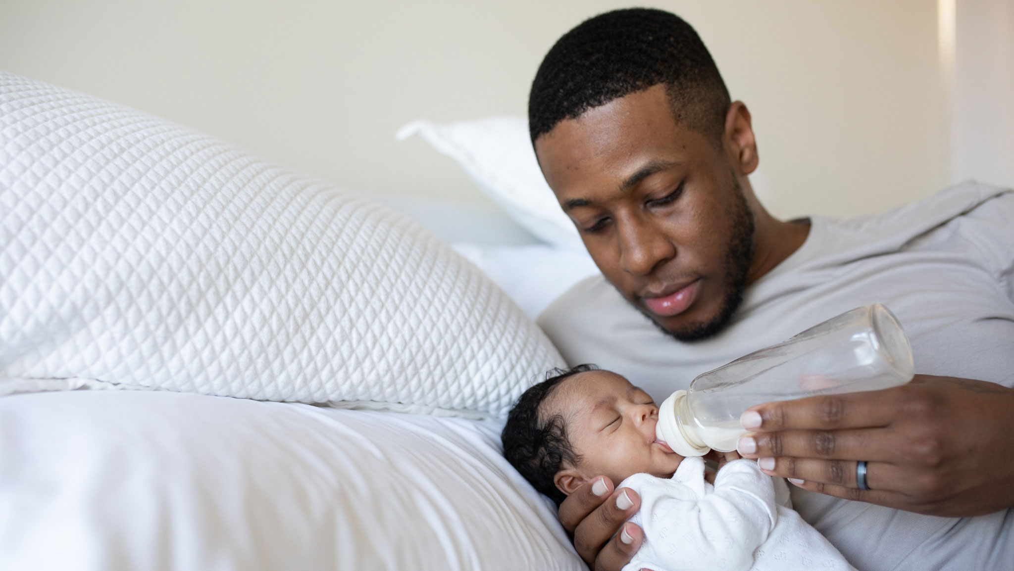 dad bottle feeds newborn baby 