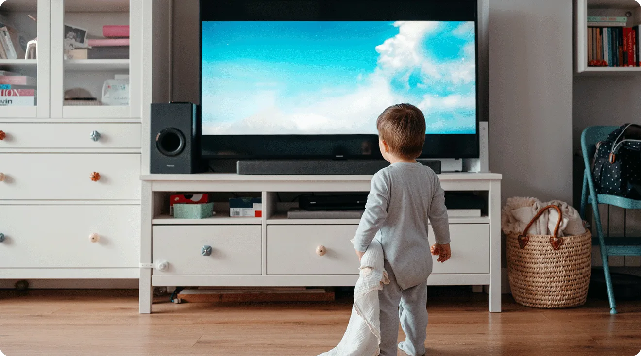 toddler standing in front of TV at home