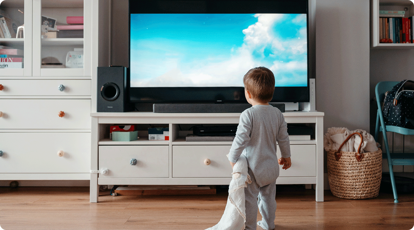 toddler standing in front of TV at home