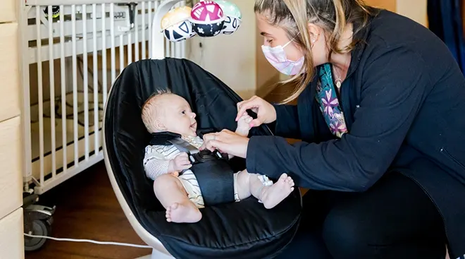 NICU nurse caring for baby in hospital